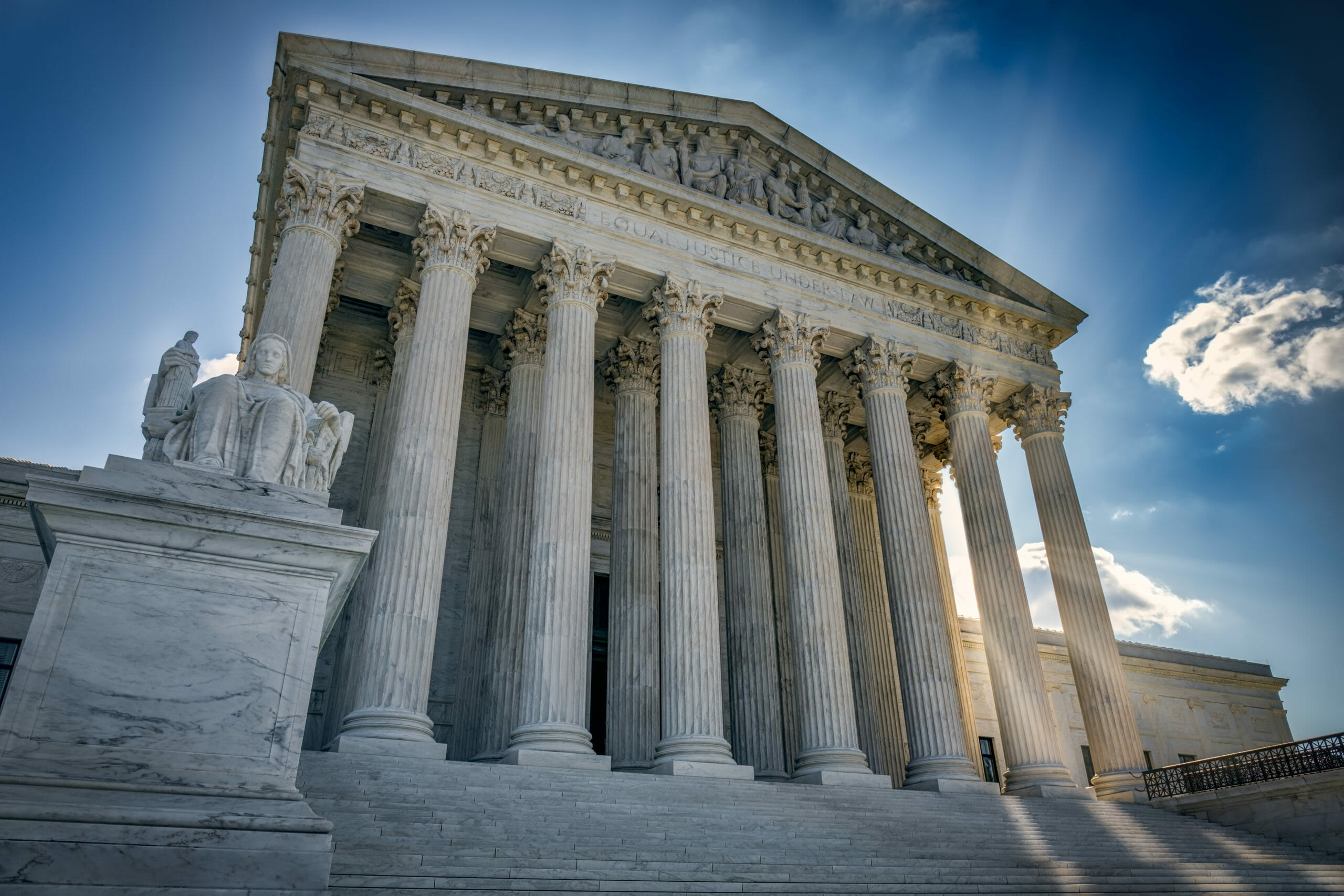 The Supreme Court against a blue sky backdrop.
