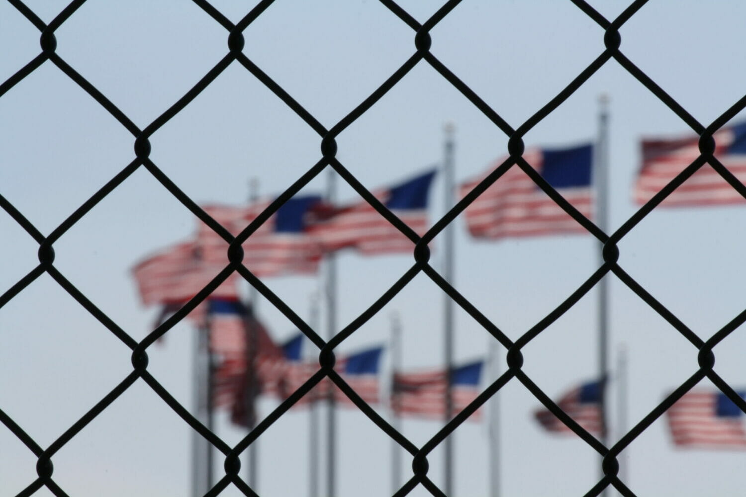 US flags behind a fence