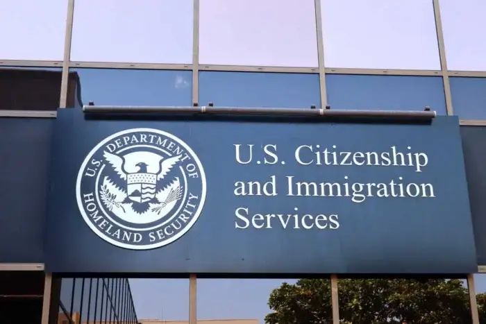 USCIS logo on sign New Data Shows USCIS Backlogs Hit Record High Under Trump in 2025