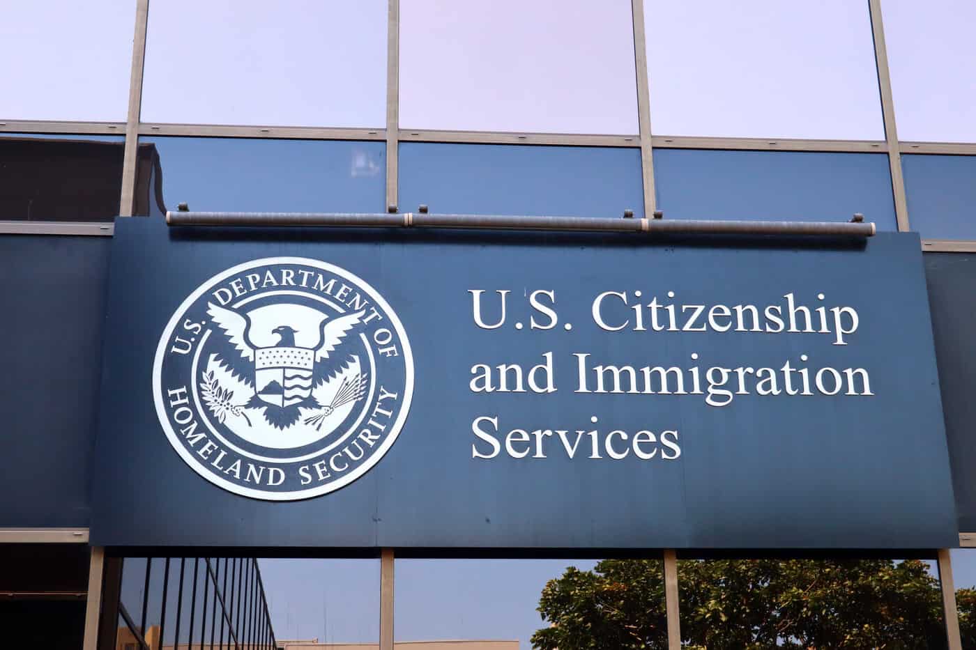 USCIS logo on sign New Data Shows USCIS Backlogs Hit Record High Under Trump in 2025