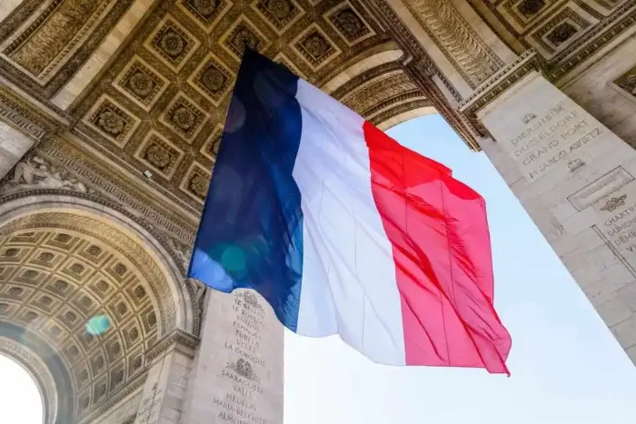 French flag hanging from old building outside